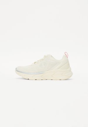 Krémová atletická obuv s textúrovaným sieťovaným zvrškom, reflexnými striebornými akcentmi a gumovou podrážkou. Obsahuje ružový štítok na päte.