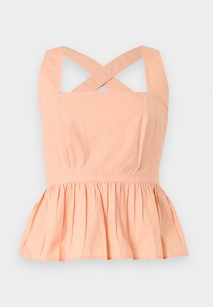 Brzoskwiniowy top bez rękawów z krzyżowanymi ramiączkami i marszczonym detalem peplum w talii na jasnym tle.