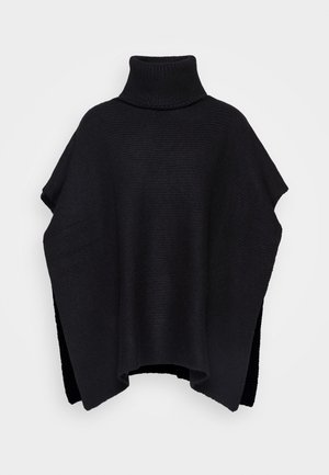 Black knit poncho with a high turtleneck and side slits. Features a textured surface and a loose, oversized shape for comfort.