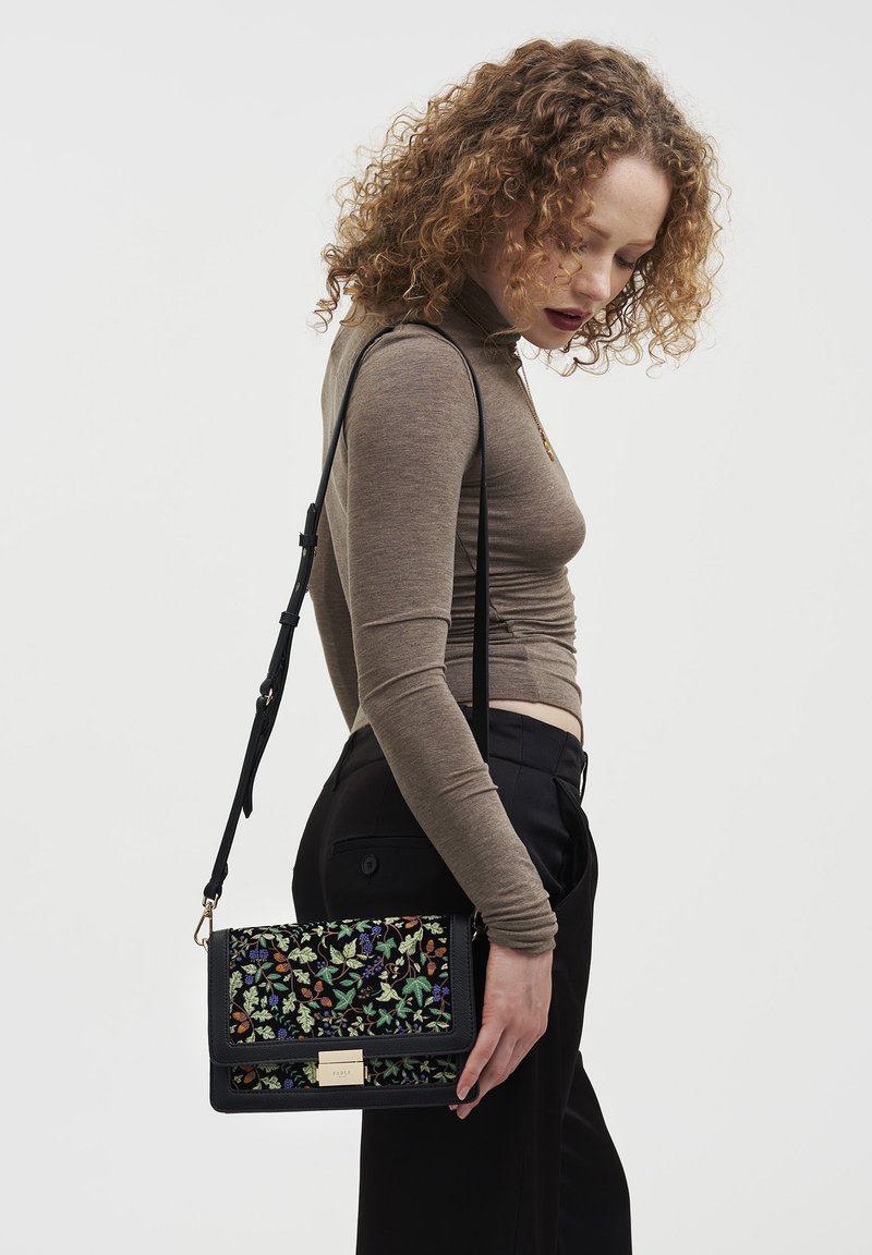 Black crossbody bag with embroidered floral designs in green, blue, and orange. Features a gold hardware clasp and adjustable strap.