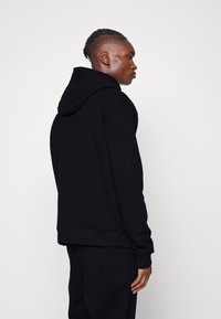 Karl Kani ESSENTIAL TRACKSUIT SET UNISEX - Tracksuit - black