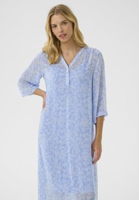 Light blue dress with floral pattern, v-neckline, three-quarter sleeves, and soft, flowing fabric for a comfortable fit.