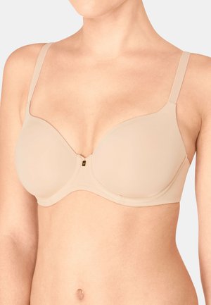 Reggiseno beige con coppe sagomate e lisce, spalline regolabili e un piccolo dettaglio oro al centro. Tessuto morbido e design senza cuciture.