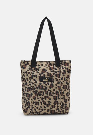 Sac cabas beige avec des taches léopard noires et marron, poignées noires et un patch logo Puma à l'avant.