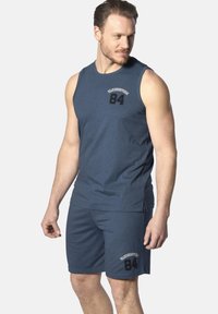 Men's sportswear set in navy blue. Features a sleeveless top with a round neckline and shorts, both with printed accents and a soft texture.