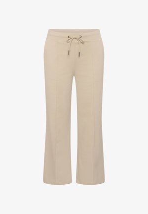 Pantalon large beige avec ceinture élastique et cordon de serrage à l'avant, doté de coutures verticales pour un look soigné.