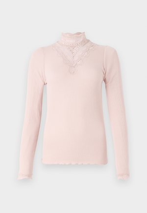 Long-sleeve pink ribbed top with a high lace collar and decorative lace trim along the neckline and sleeves. Soft texture, fitted design.