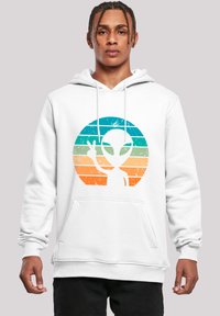 White hoodie featuring a front graphic of an alien and peace sign in blue to orange gradient stripes. Material appears soft and fleece-lined.