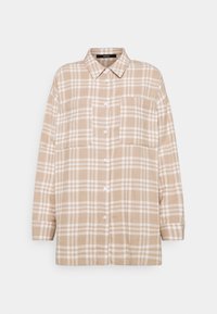 Chemise à carreaux beige et blanche à manches longues avec boutons, deux poches poitrine et col classique, présentée à plat sur fond blanc.