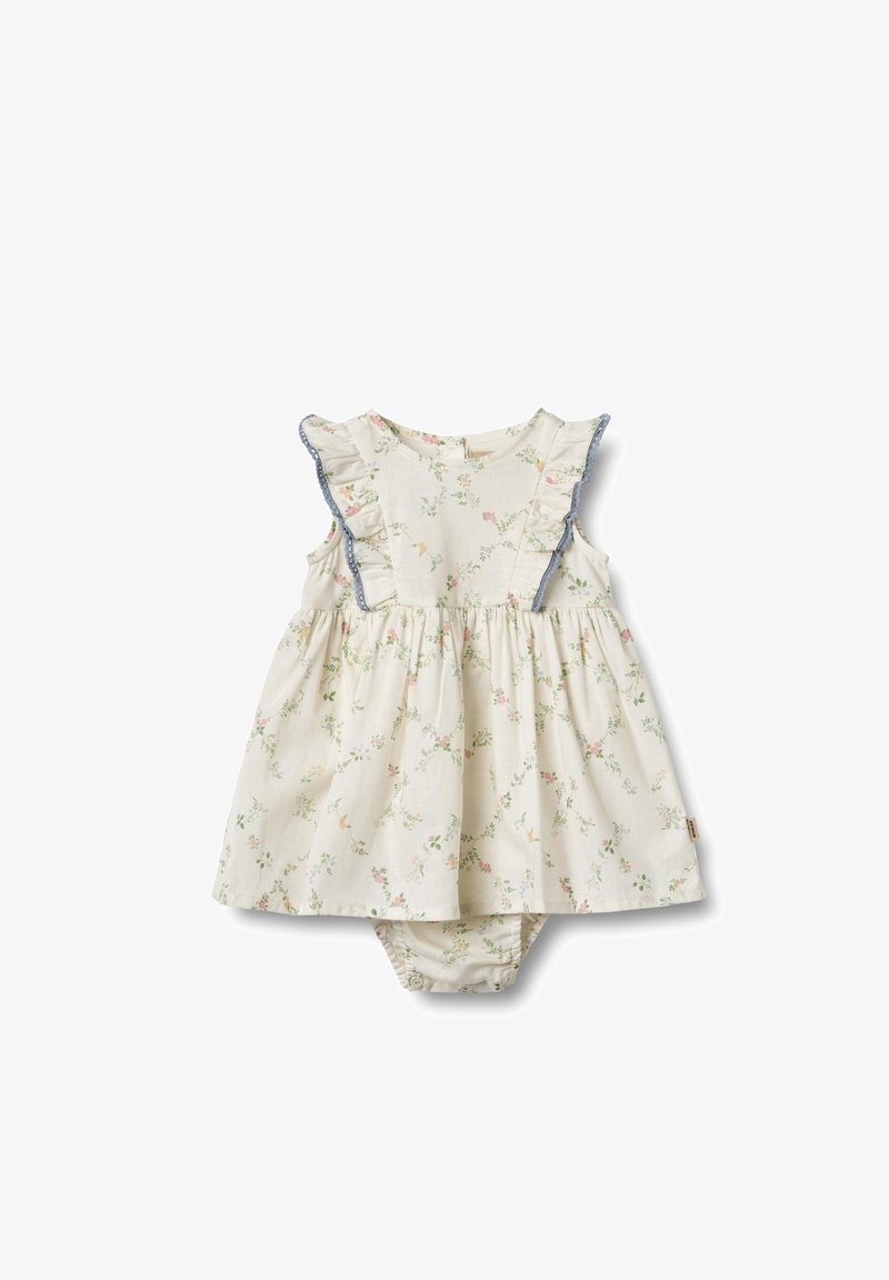 Šaty s květinovým vzorem v světle béžové barvě s volány na ramenou a modrým lemováním. Nařasený pas a připojené kalhotky pro pohodlné nošení.