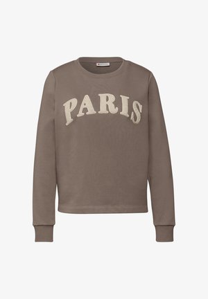 Brązowa bluza z okrągłym dekoltem i długimi rękawami. Na piersi znajduje się napis „PARIS” wykonany białym, teksturowanym haftem. Miękka struktura materiału.