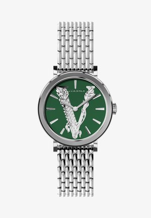 Silver metal wristwatch with a green dial, featuring a prominent engraved ‘V’ design, and a textured metal mesh strap.