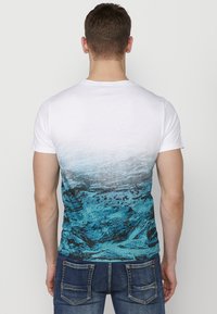 Men's short-sleeve T-shirt featuring a gradient design, transitioning from white to blue, with a textured ocean graphic on the back.