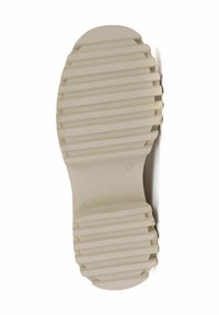 Cream rubber shoe sole with a ridged texture, rounded toe, and number "37" molded into the design. Clean and minimalist aesthetic.