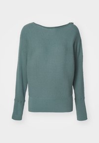 Vihreä ribattua neuletta leveällä kaula-aukolla, pitkät hihat ja teksturoidulla pinnalla. Yhdellä olalla pieni vetoketjukiinnitys.