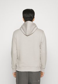 Calvin Klein Jeans MONOLOGO - Jersey con capucha - porpoise