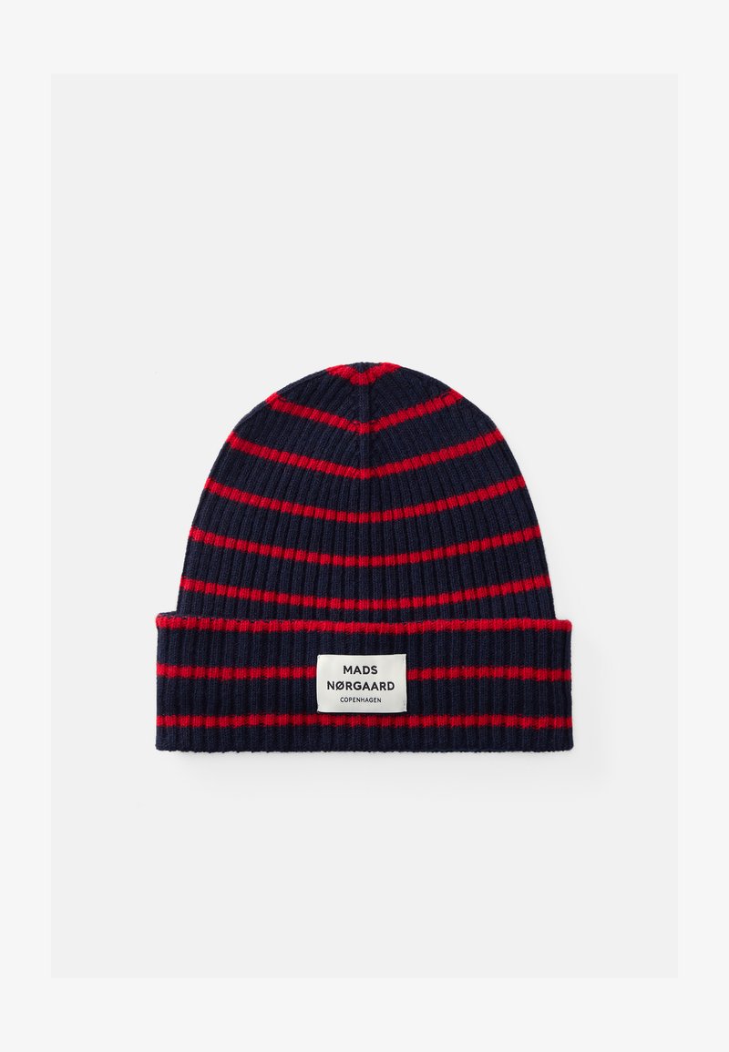 Knit beanie in navy with red horizontal stripes, featuring a white label at the front with the brand name and location.