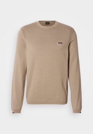 Beež kootud kampsun pikkade varrukatega, ümmarguse kaelusega, soonikkoes detailidega ja väikese musta "BOSS" logoga rinnal. Pehme tekstuur, klassikaline lõige.