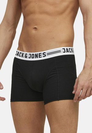 Boxers en coton noirs avec une ceinture élastique blanche portant le texte "JACK & JONES". Design près du corps avec une texture lisse.