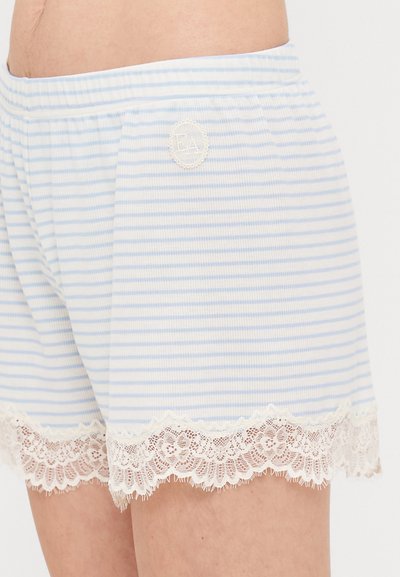 Light blue striped shorts with white lace trim at the hem. Elastic waistband, soft fabric, and a circular logo patch on the side.