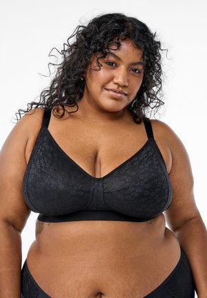 Black lace bralette with a smooth band, featuring a deep V-neckline and adjustable straps. Textured lace pattern covers the cups.
