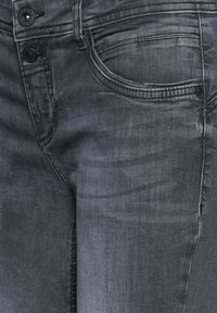 Mörkgrå denimjeans med en lätt glans. Har standardfickor, två knappar och subtila slitningar. Skräddarsydd passform med minimalt slitage.