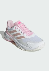 White athletic shoe with pink accents, featuring mesh and synthetic material, textured panels, and a cushioned sole. Three stripes on the side.