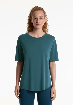 Teal kortemouwen top met een ronde hals, een gladde textuur en een relaxte pasvorm. Gecombineerd met bijpassende teal leggings.