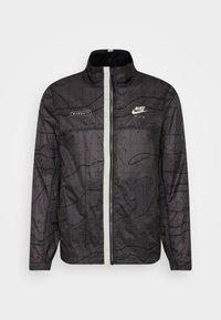 Nike Sportswear Corta-vento - anthracite/light bone