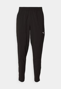 Zwarte sportbroeken van lichtgewicht stof met een elastische tailleband. Heeft taps toe lopende benen en een klein wit logo op de linkerdij.