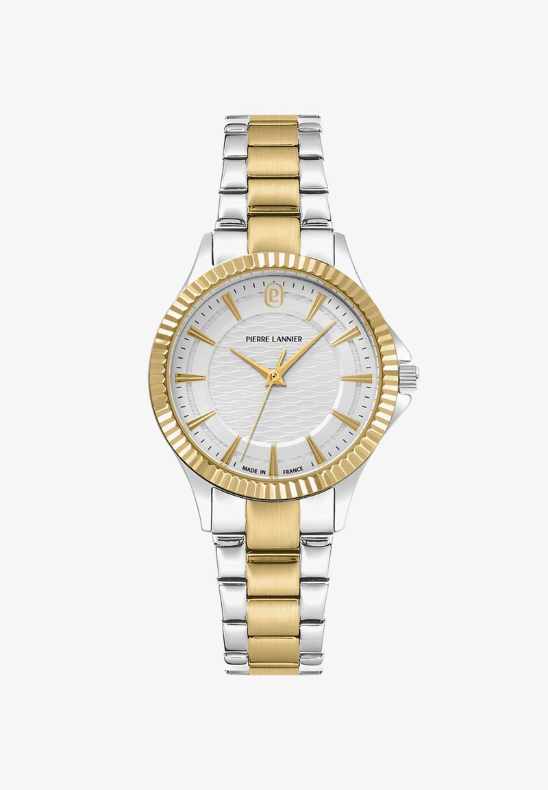 Sidabrinė ir auksinė laikrodžio apyrankė su tekstūruotu baltu ciferblatu, auksiniais akcentais ir dviejų tonų metaline grandinėlė. Ypatybės - išgaubtas auksinis rėmelis ir logotipas.