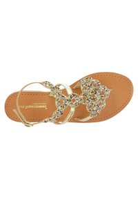Gold thong sandal featuring a flat sole, brown insole, and beaded floral embellishments. The straps are metallic and embellished with colored beads.