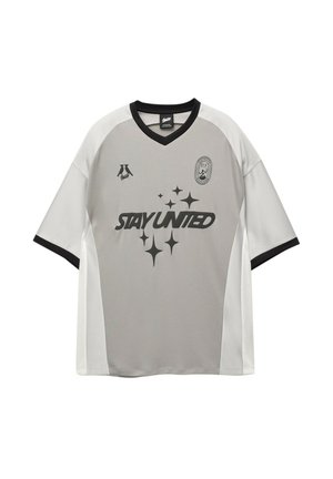 Gray soccer jersey with black accents, short sleeves, and a v-neck. Features "STAY UNITED" in bold lettering and decorative star details.