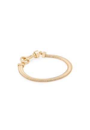 Bracciale in oro con un design flessibile a forma di serpente e una chiusura sicura. Texture liscia con un evidente lucentezza metallica.