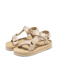 Sandalias beige con parte superior de tela texturada, correas ajustables, suela acolchada y suela exterior de goma duradera para mayor tracción.