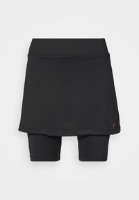 Falda deportiva negra con pantalones cortos incorporados, hecha de tela elástica. Presenta una textura suave y un diseño elegante con un detalle de logotipo.