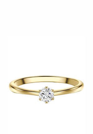 Anillo delgado de oro con un único diamante redondo y claro sujeto por seis garras en una banda lisa sobre un fondo blanco.