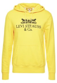Sudadera amarilla de mezcla de algodón, con un bolsillo delantero, capucha con cordón y estampado gráfico negro de "Levi Strauss & Co.".
