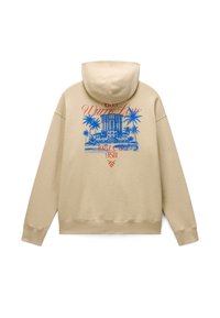 Sweat à capuche beige avec un graphisme bleu représentant un bâtiment et des palmiers, texte rouge "White Lane," "1987," et d'autres chiffres au dos.