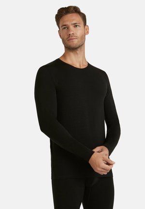 Black long-sleeve shirt made from soft fabric with a crew neckline; fitted design and smooth texture; paired with matching black bottoms.