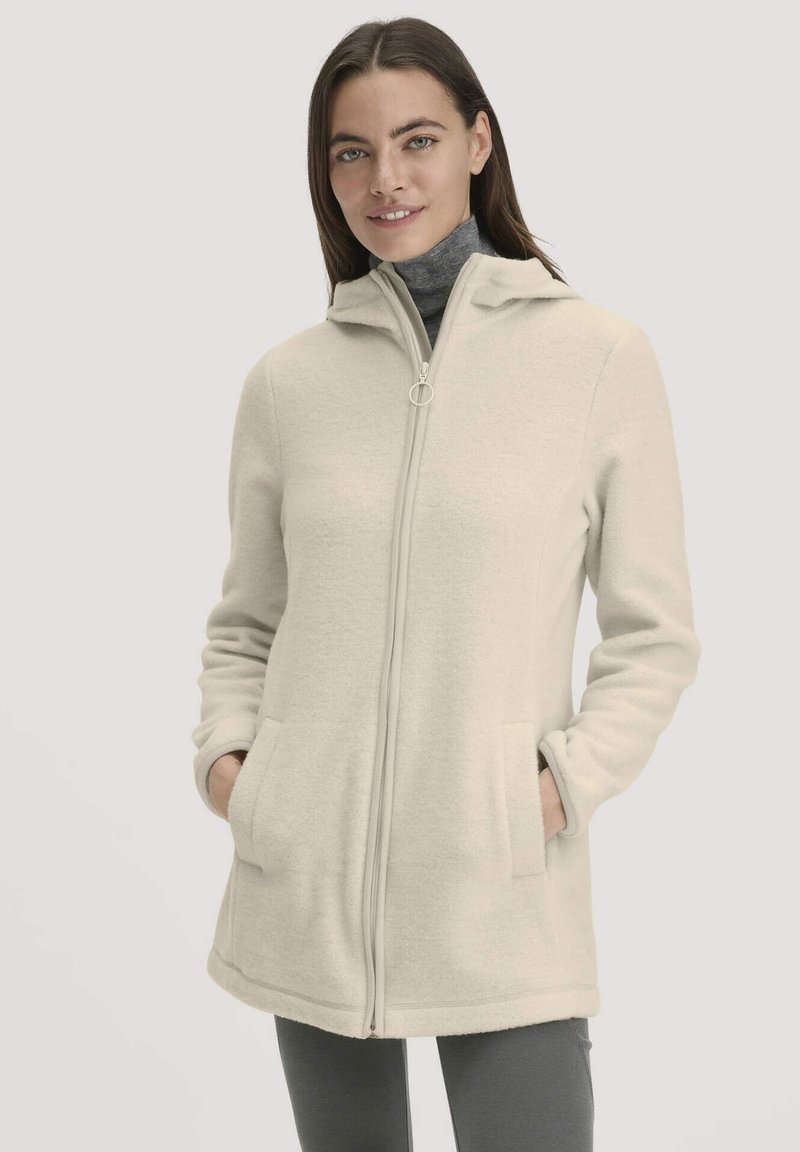 Cremefarbener Fleece-Cardigan mit Reißverschluss, Kapuze und zwei Fronttaschen. Besitzt eine weiche Textur und eine lockere Passform.