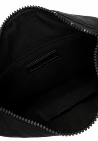 Black zippered pouch with a textured exterior, featuring an inner compartment with a smooth fabric lining and a small zippered pocket.