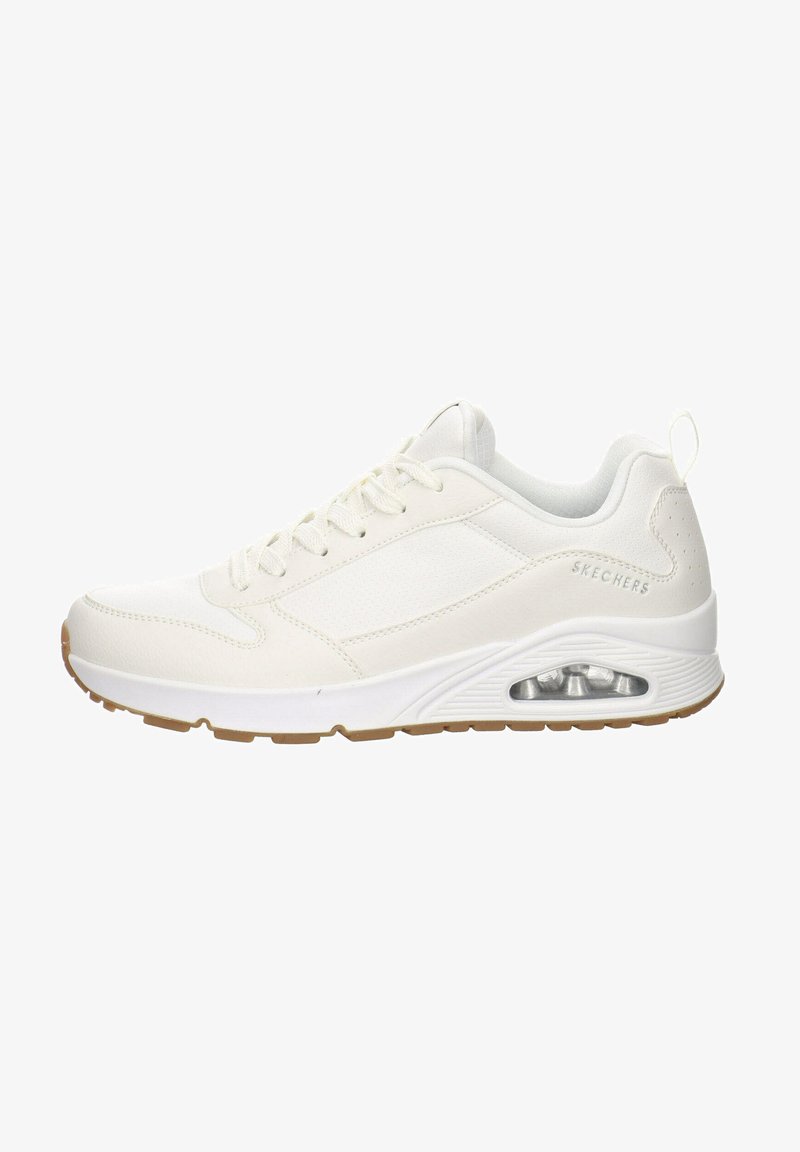 Chaussures de sport blanches avec un dessus synthétique lisse, un design à lacets, une semelle rembourrée et un détail de coussin d'air visible au talon.