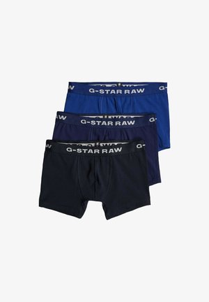 Pack de tres calzoncillos G-Star RAW en azul marino, azul oscuro y negro. Presentan cinturilla con logo, material de algodón y textura suave.