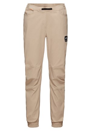 Pantalons légers beiges au design fuselé, avec des poignets élastiques, des poches latérales et un patch logo sur la cuisse gauche. Texture lisse.