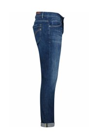 Slanke jeans in donkerblauw. Heeft een middelhoge taille, vijf zakken en omgeslagen enkels met groene stiksels. Gladde textuur.