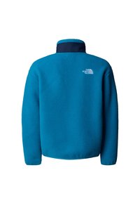 Μπλε φλις μπουφάν με ψηλό γιακά, υφασμάτινη υφή και διακριτικό λογότυπο στο πάνω μέρος της πλάτης. Μακριά μανίκια και άνετη εφαρμογή.