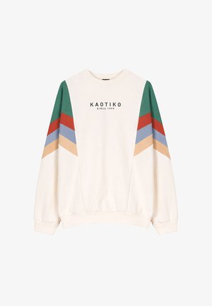 Weißes Sweatshirt mit grünen, roten, blauen und beigen Chevron-Streifen auf den Ärmeln und dem Schriftzug "KAOTIKO SINCE 1999" auf der Brust.