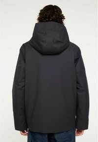 Grå vattentät jacka med stor huva, med en slät yta och minimalistisk design, visad bakifrån.