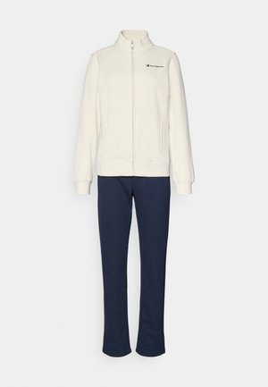 White zip-up jacket with high collar and black logo, paired with navy blue sweatpants; both made of soft, textured fabric.